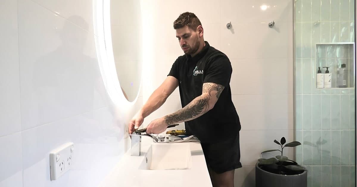 Hills Plumbing and Gas working on a hot water system on the Gold Coast.