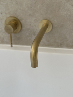 Brass wall-mounted bath spout
